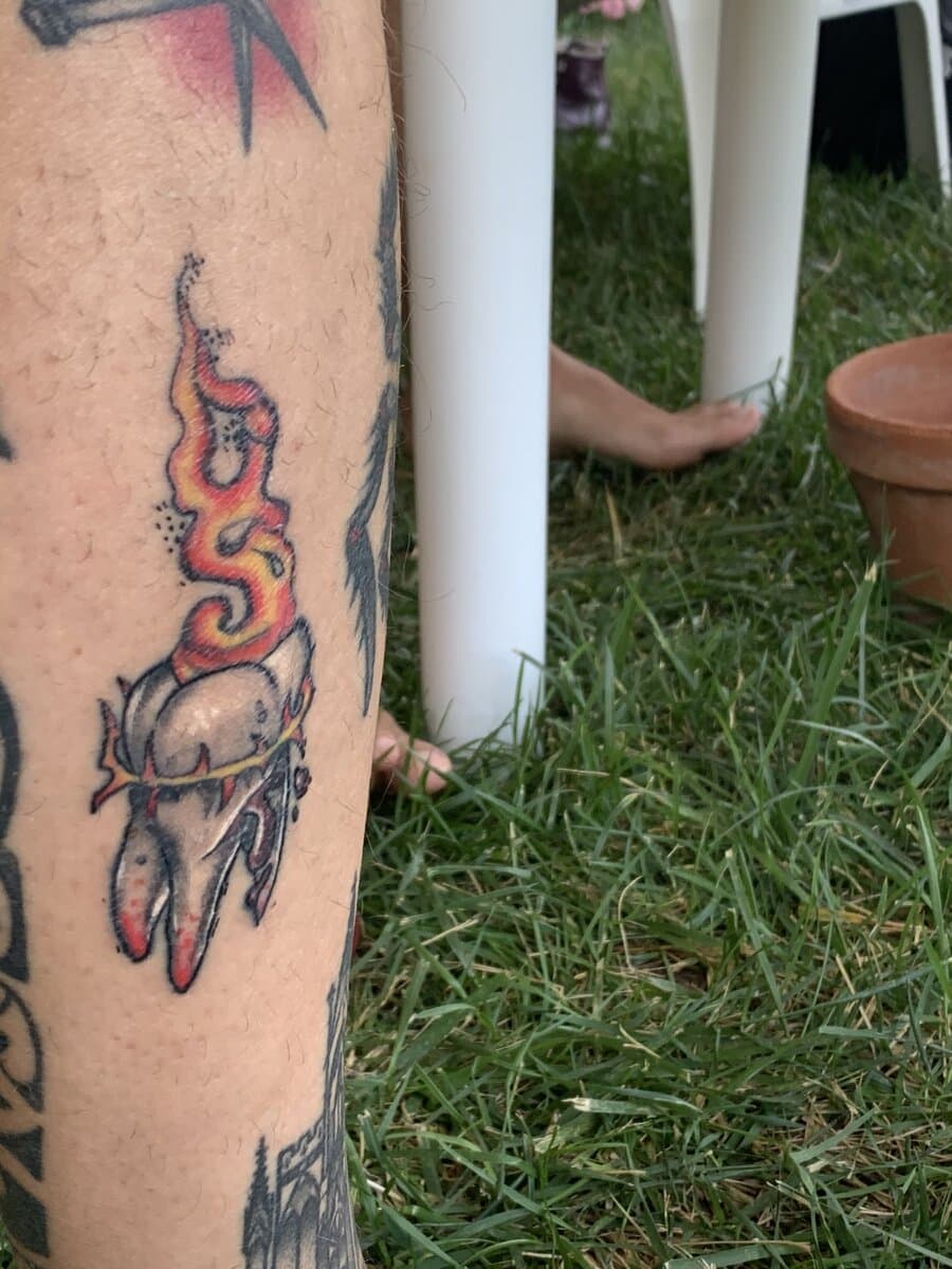 domencre-tattoo-artist-teeth-fire-leg