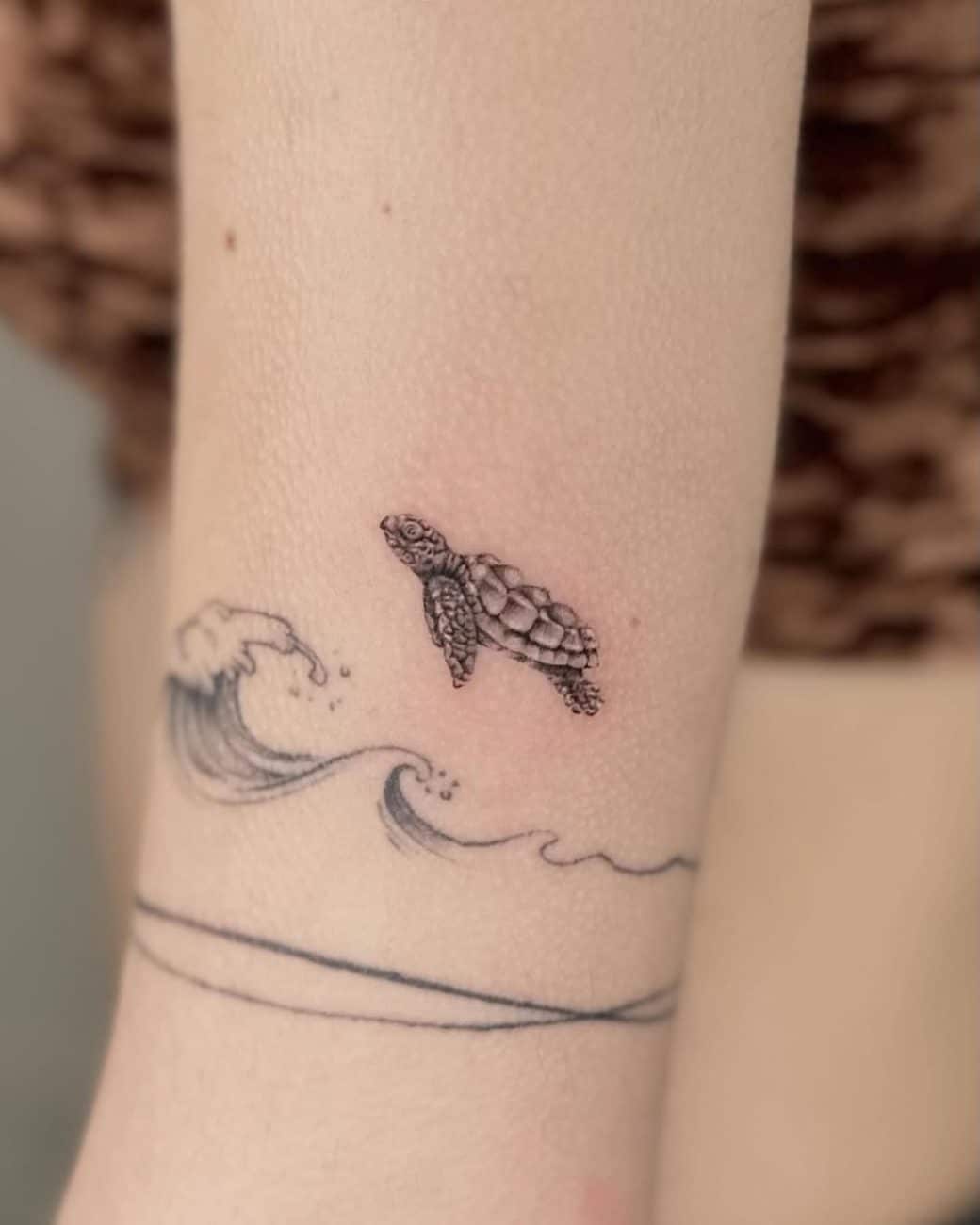 tiny-turtle-tattoo-with-waves-micro-realism-about-ink-tattoo